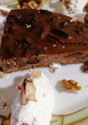 A picture of Castagnaccio with Ricotta Cream and Walnut-Stuffed Dried Figs.