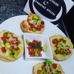 A picture of Cheesy bread with tomatoes & avocado salsa.
