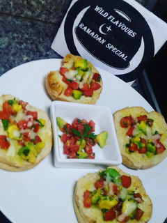 A picture of Cheesy bread with tomatoes & avocado salsa.