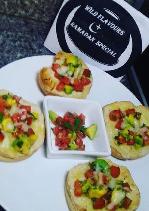 A picture of Cheesy bread with tomatoes & avocado salsa.
