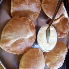 A picture of Full of love: shrikhand and puri.