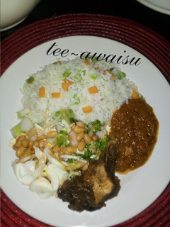 A picture of White rice,stew and salad.