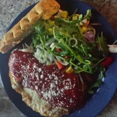 A picture of Chicken parm w/leek arugula salad.