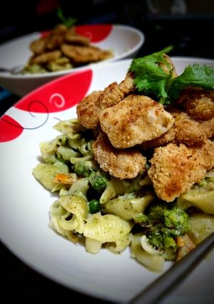 A picture of Spinach Pasta with Baked Chicken Nuggets.