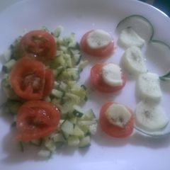 A picture of Tomato and cucumber salad.