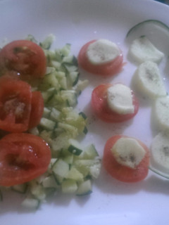 A picture of Tomato and cucumber salad.