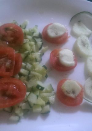 A picture of Tomato and cucumber salad.