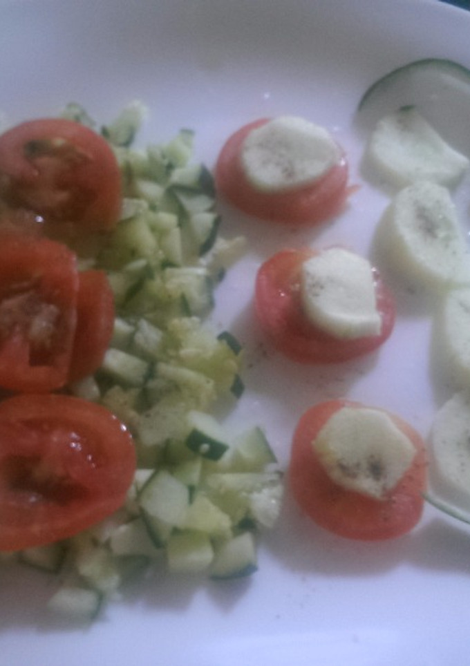 A picture of Tomato and cucumber salad.