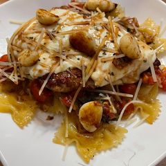 A picture of Bruschetta Caprese Chicken over Bowtie Pasta.