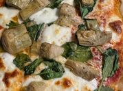 A picture of spinach and cheese pizza