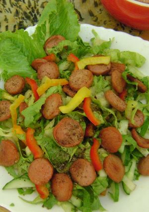 A picture of Veggie Salad with Sausages.