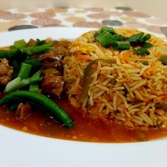 A picture of Beef Chilli with fried rice.