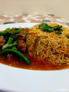 A picture of Beef Chilli with fried rice.