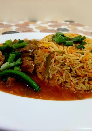 A picture of Beef Chilli with fried rice.