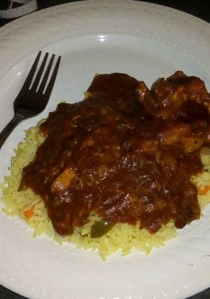 A picture of Tomato chilli chicken with savoury rice.