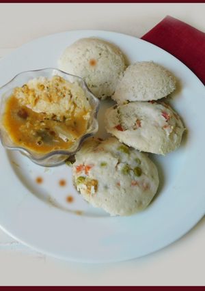 A picture of Idli with oats and veggies, sambar.
