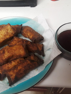 A picture of Thanksgiving leftover egg rolls with cranberry sweet & sour sauce.