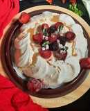 Pavlova Served with Whipped Cream and Fruits