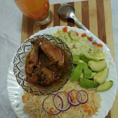 Kienyeji chicken with carrot rice and steamed cabbage A picture of Kienyeji chicken with carrot rice and steamed cabbage.