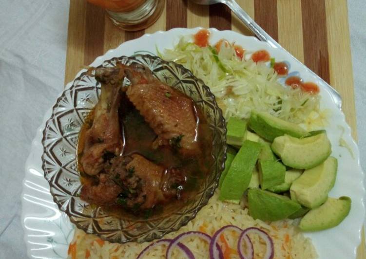 Kienyeji chicken with carrot rice and steamed cabbage