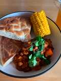 Five bean chilli with corn on the cob and flatbread