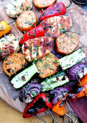 A picture of Grilled halloumi and vegetable skewers.