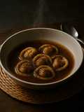 Tortelli in crema di castagne e in brodo affumicato