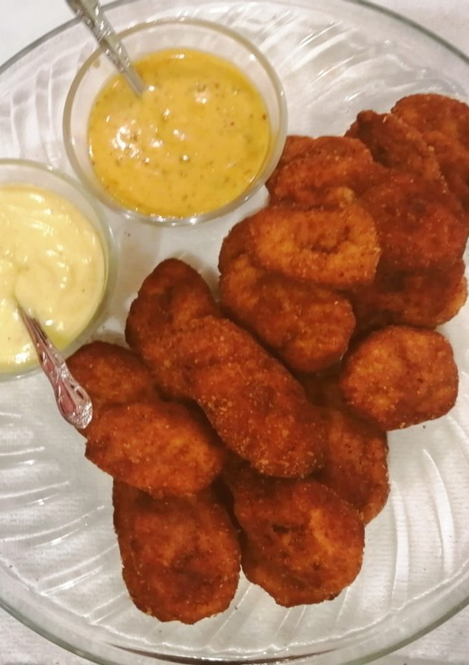 Una foto de Nuggets de pollo acompañado con mayonesa y aderezo de chipotle