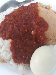 A picture of Rice,moimoi and pepper sauce.