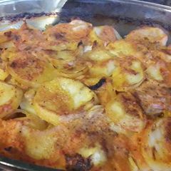A picture of Baked potato in tomatoe sauce.