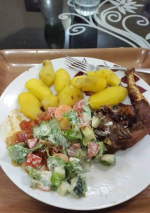 A picture of Boiled potatoes,fried chicken and salad.