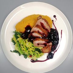 A picture of Pan roasted goose breast/ cherry sauce/ sweet potato mash/savoy.
