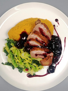 A picture of Pan roasted goose breast/ cherry sauce/ sweet potato mash/savoy.