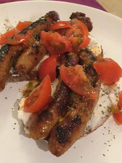 A picture of Hungry dinner: bread, sausage, ricotta, tomatoes.