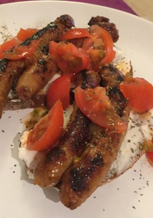 A picture of Hungry dinner: bread, sausage, ricotta, tomatoes.