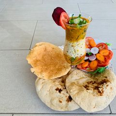 A picture of Cauliflower Sabzi,Daal fry, Naan(wheat flour),Jeera rice,Salad and papad.