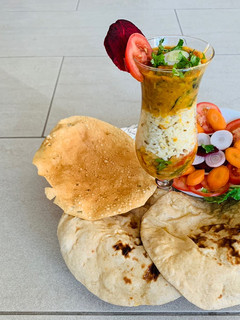 A picture of Cauliflower Sabzi,Daal fry, Naan(wheat flour),Jeera rice,Salad and papad.