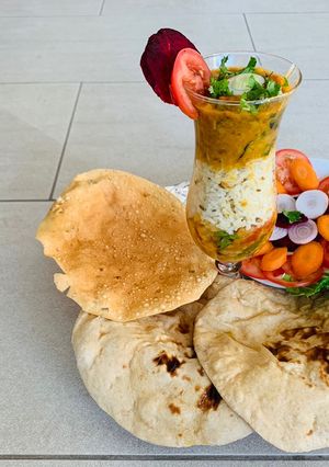 A picture of Cauliflower Sabzi,Daal fry, Naan(wheat flour),Jeera rice,Salad and papad.