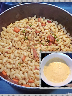 A picture of Red veggies pasta with white sauce.