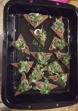 A picture of Vegan poached pear rocket and red onion 'pizza'.