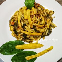 A picture of Spaghetti Spinach tomato sauce with babycorn.