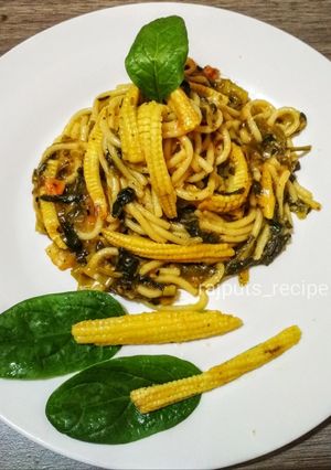 A picture of Spaghetti Spinach tomato sauce with babycorn.