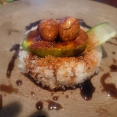 A picture of "Make Your Bed!" (Quail Eggs, Avocado, Cucumber, Rice, Sauce).