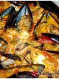 Steamed mussels with colored peppers and feta cheese