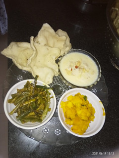 A picture of Rice kheer mashed potato fried bhindi rice papad.