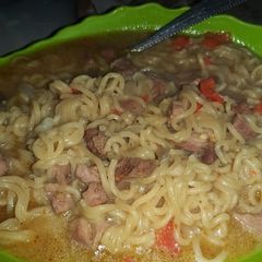 A picture of Noodles and beef soup.