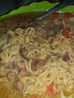 A picture of Noodles and beef soup.