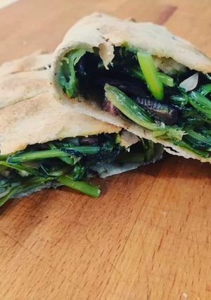 A picture of Calzones with Wild Dandelion Greens, Black Olives, and Almonds.