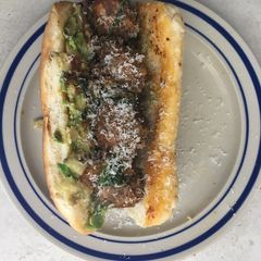 A picture of Leftover meatball sub with avocado.