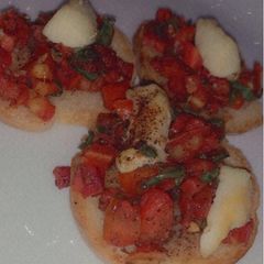 A picture of Veg Bruschetta with mozzarella cheese.